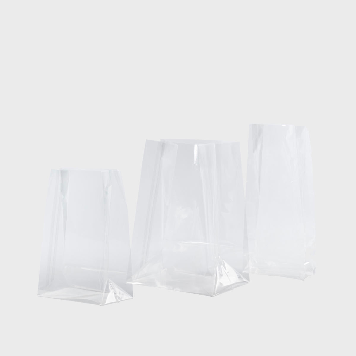 Cellophane gift bag featuring a patterned finish and heavy-duty handles.