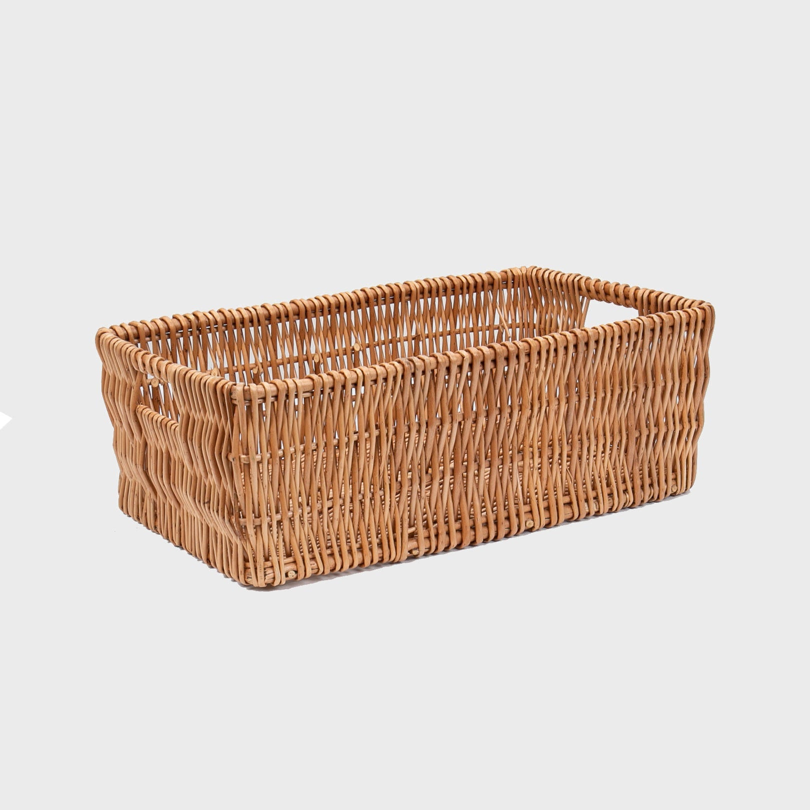 Medium deep wicker tray with handles with structured, low-profile walls and open-top design.
