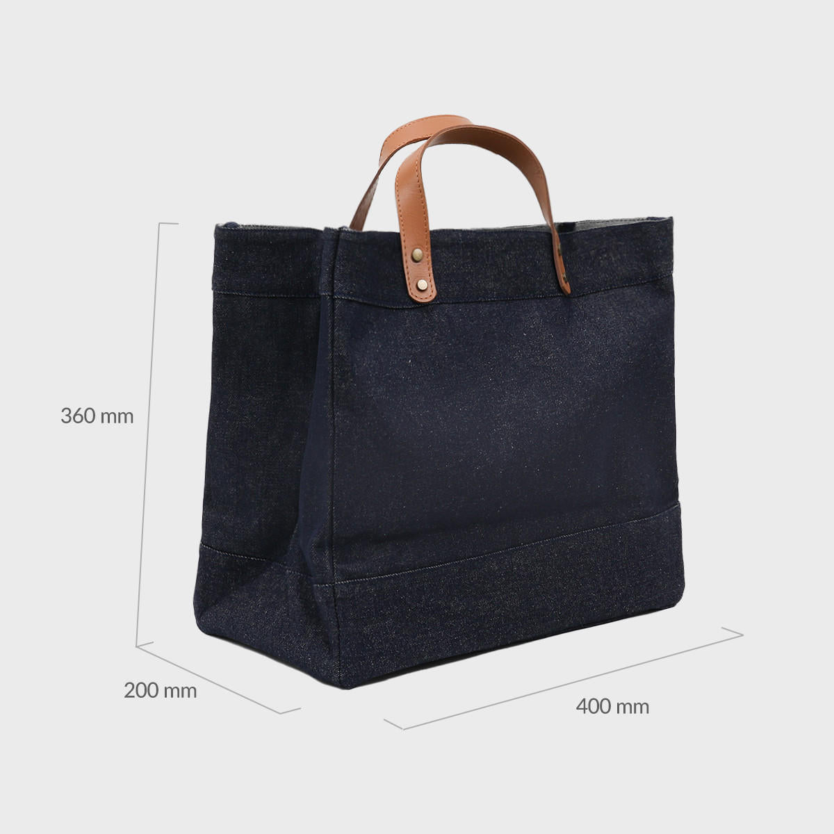 Large blue denim market bag with leather handles.