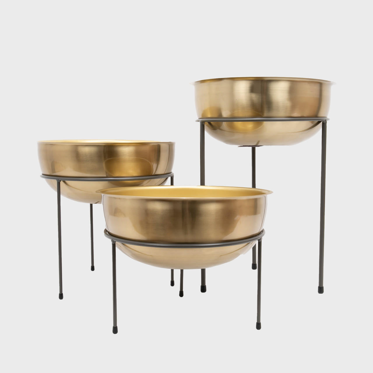 Matlock metal riser with matte brass bowl designed to add functional height and dimension.