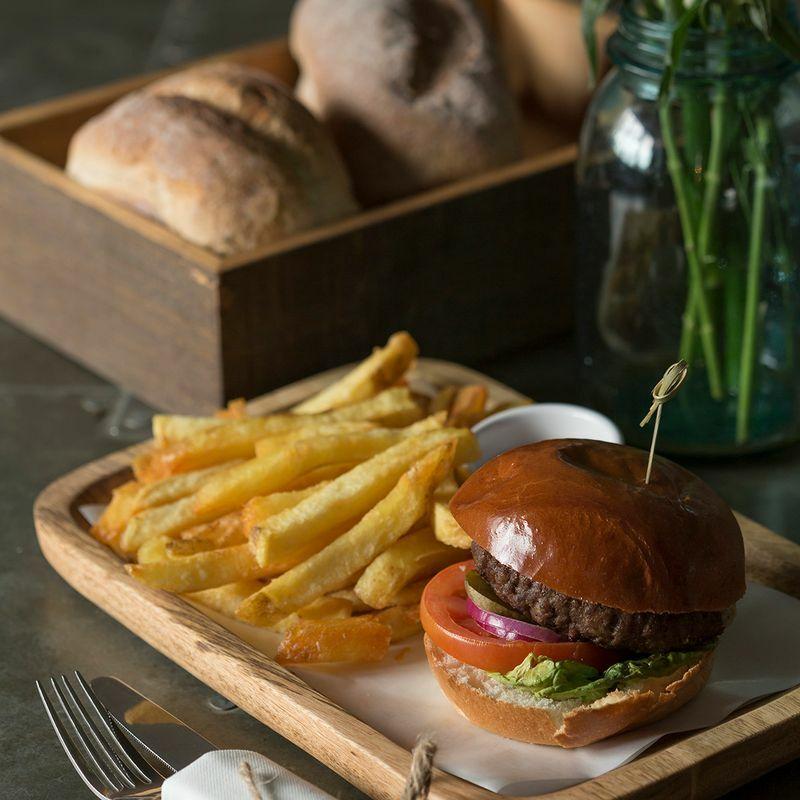 Small scooped wooden serving board crafted from durable hardwood with natural grain detail.