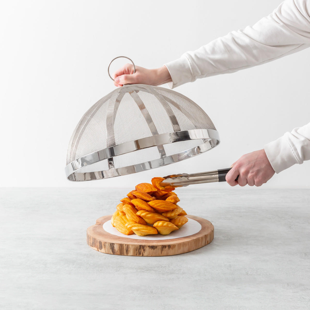 Oversized metal mesh food cover with handle.