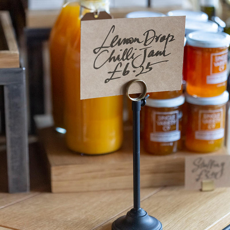 Derwent small adjustable signage stand with a clean surface for visible retail messaging.