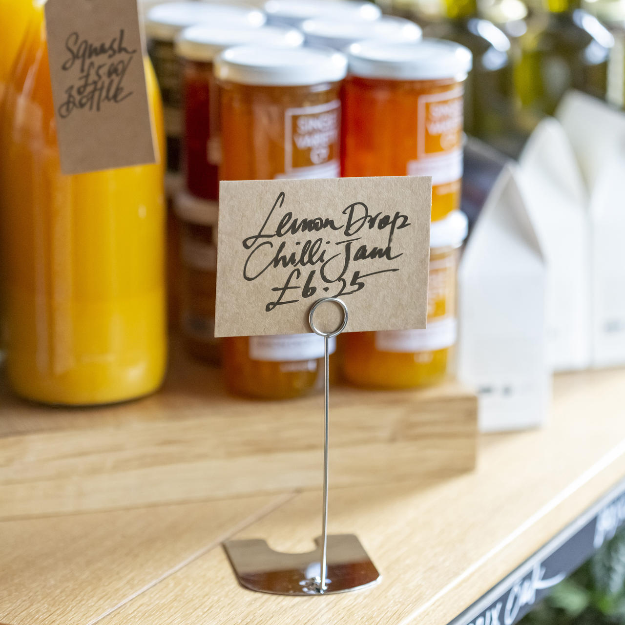 Iron plated chrome ticket holder with a clean surface for visible retail messaging.