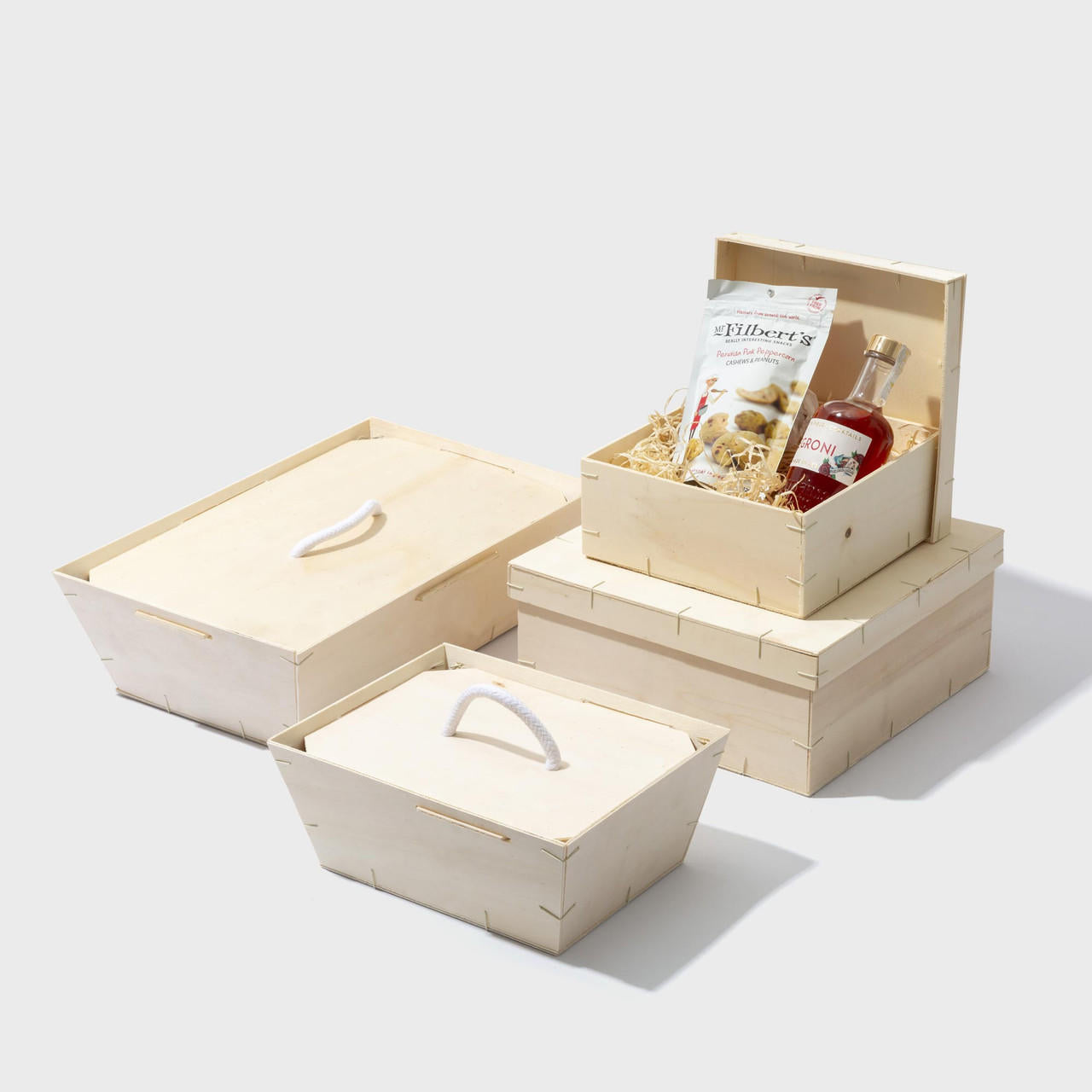 Wooden gift tray with clip on lid with structured, low-profile walls and open-top design.