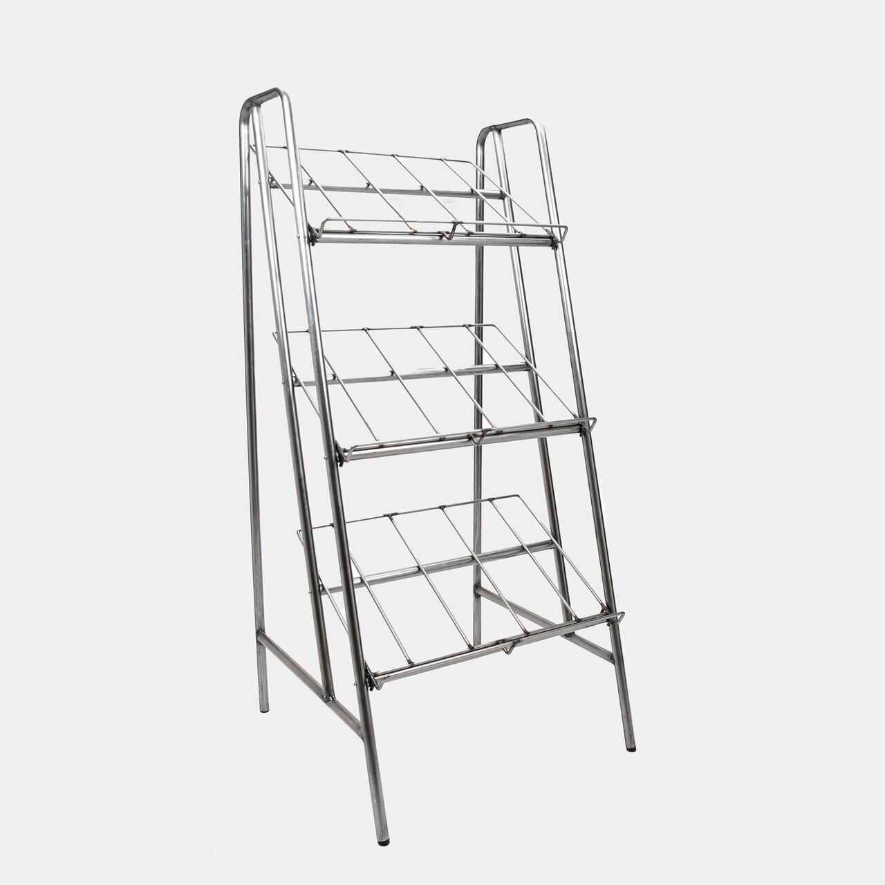 Two silver metal retail display stands with three shelves each, designed to hold various items.