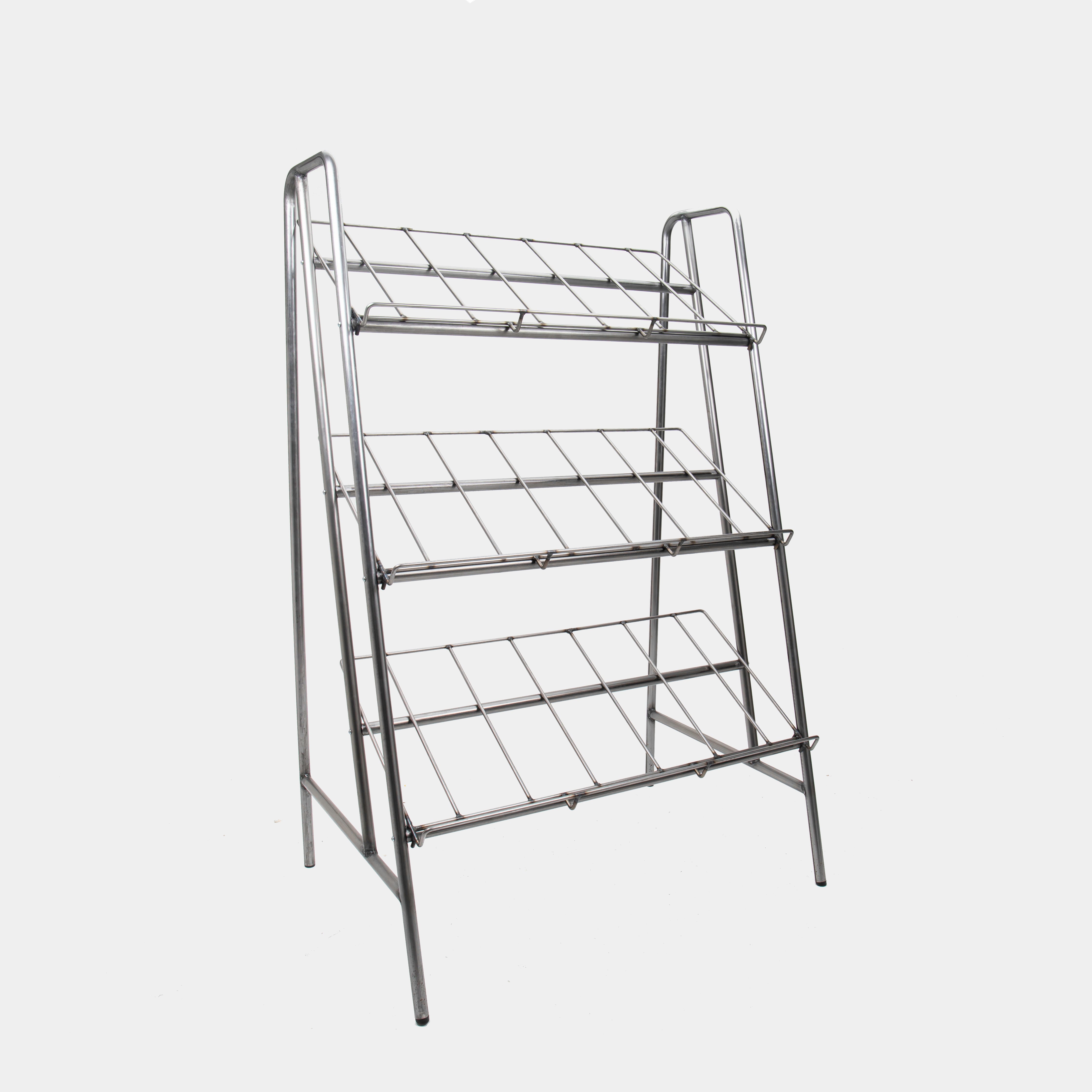 Two silver metal retail display stands with three shelves each, designed to hold various items.
