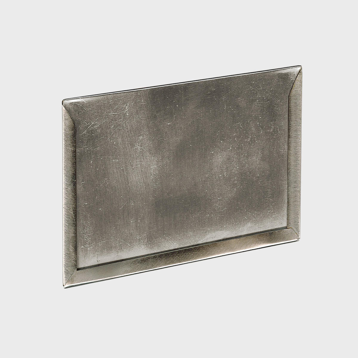 A self-adhesive silver card holder with a textured surface, designed for attaching to various surfaces.