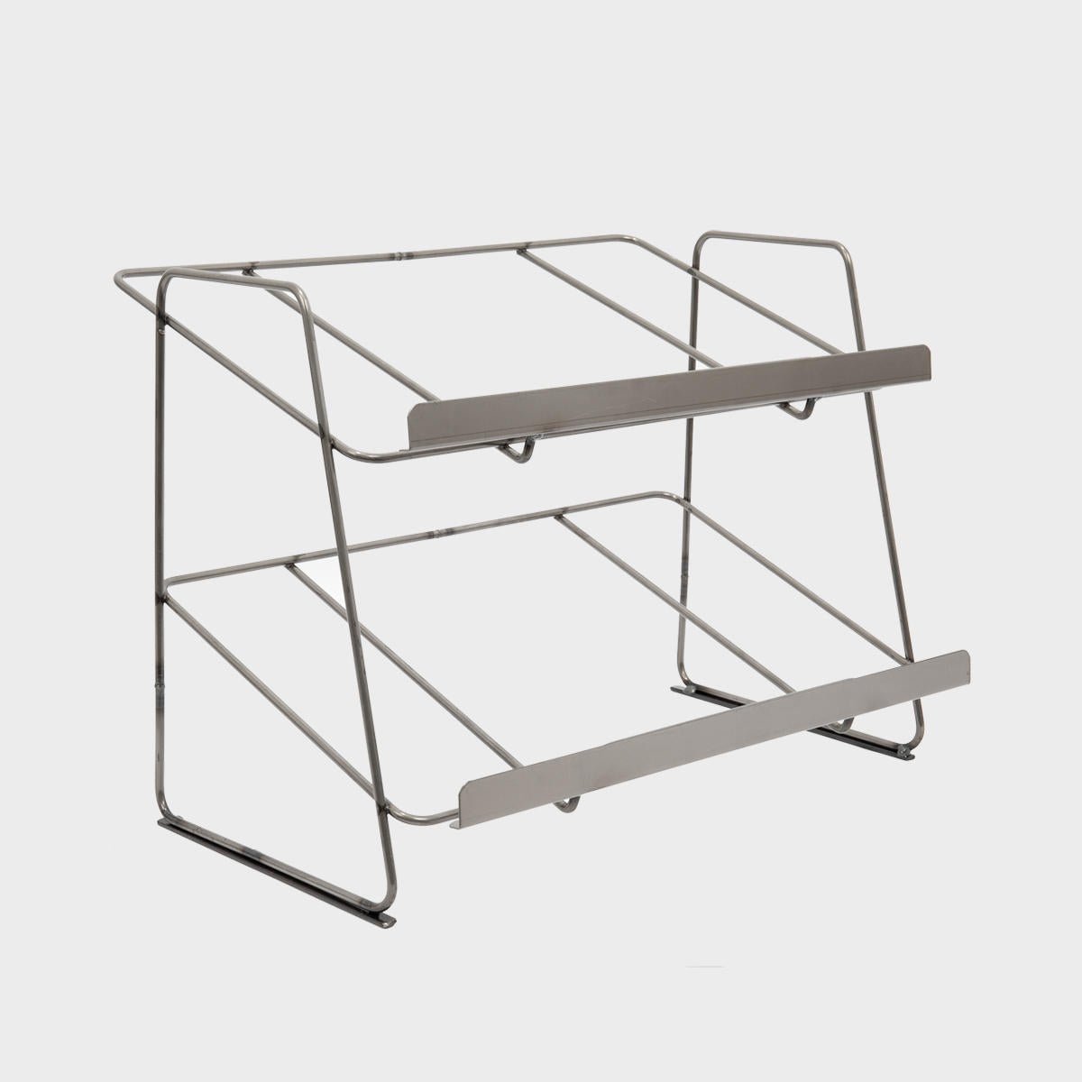 A silver tiered steel countertop display unit with a contemporary design, featuring multiple shelves for organizing items.