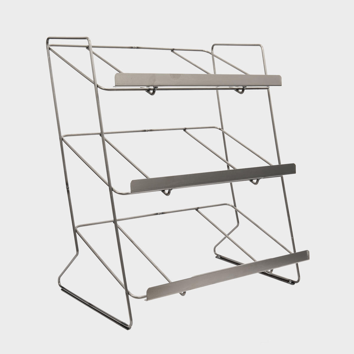 A silver tiered steel countertop display unit with a contemporary design, featuring multiple shelves for organizing items.