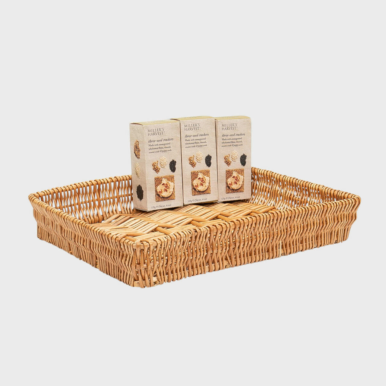 Shallow wicker basket hand-woven from natural split-wicker.