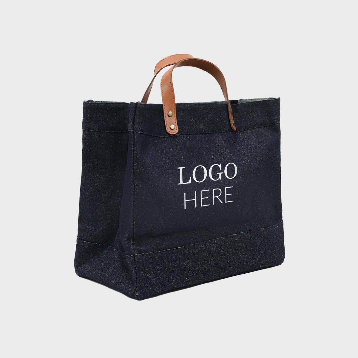 Large blue denim market bag with leather handles.