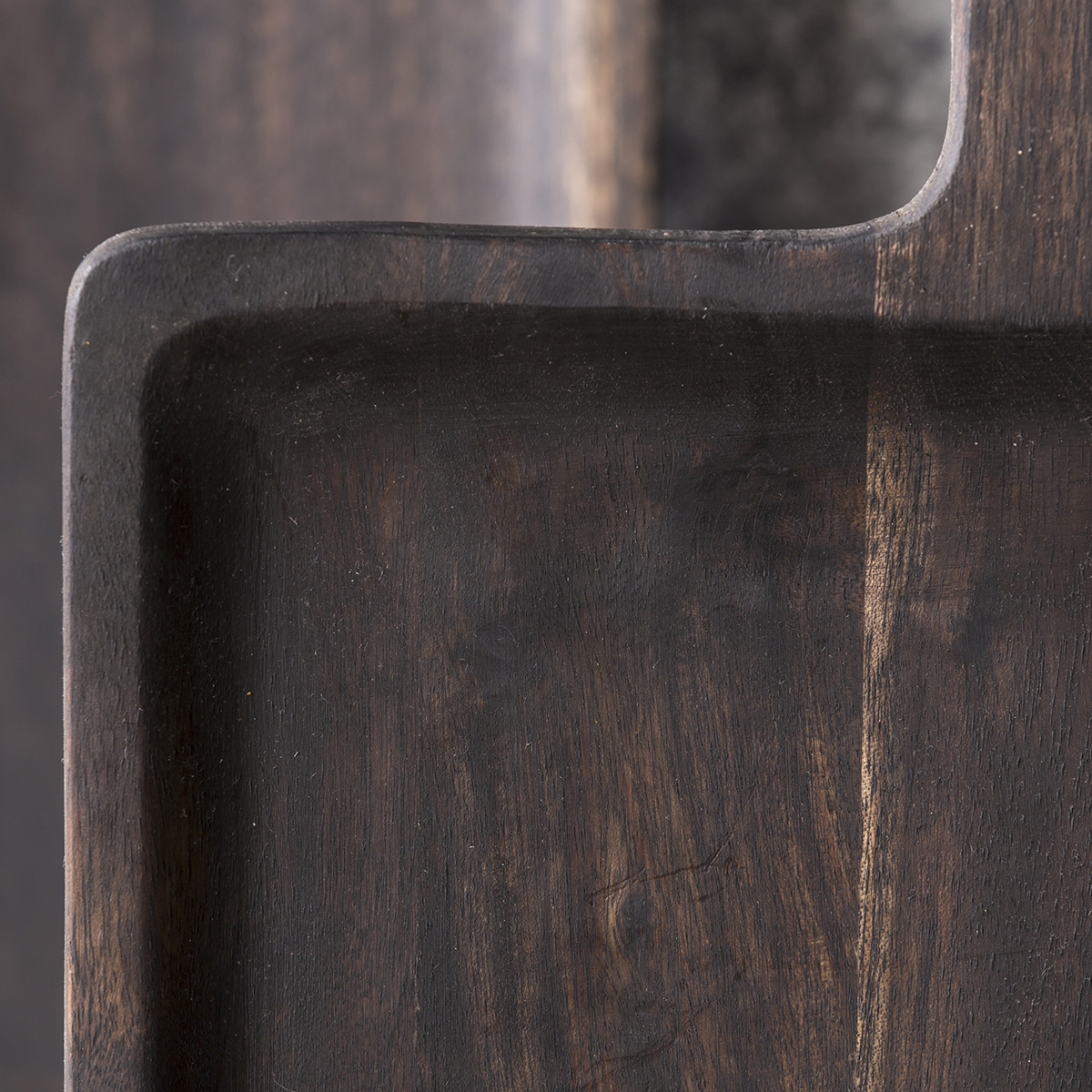 Black wooden scooped serving board crafted from durable hardwood with natural grain detail.