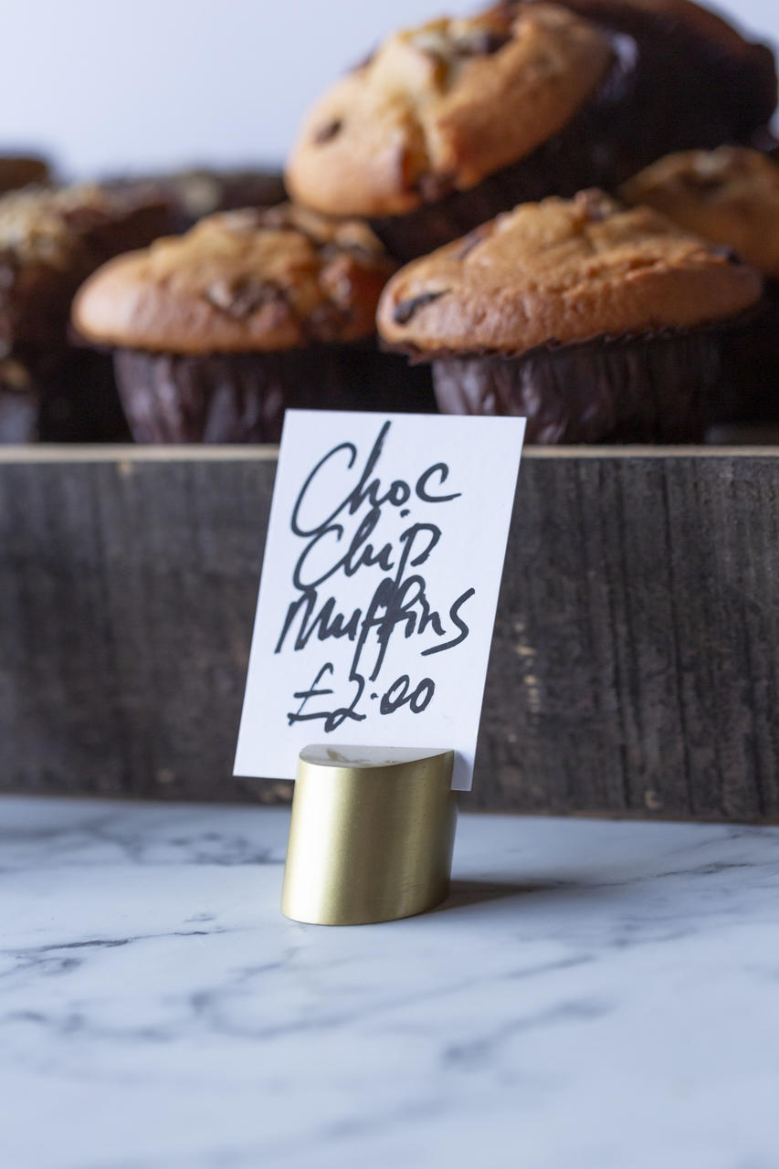 Grove angled metal ticket holder with brass finish with a clean surface for visible retail messaging.