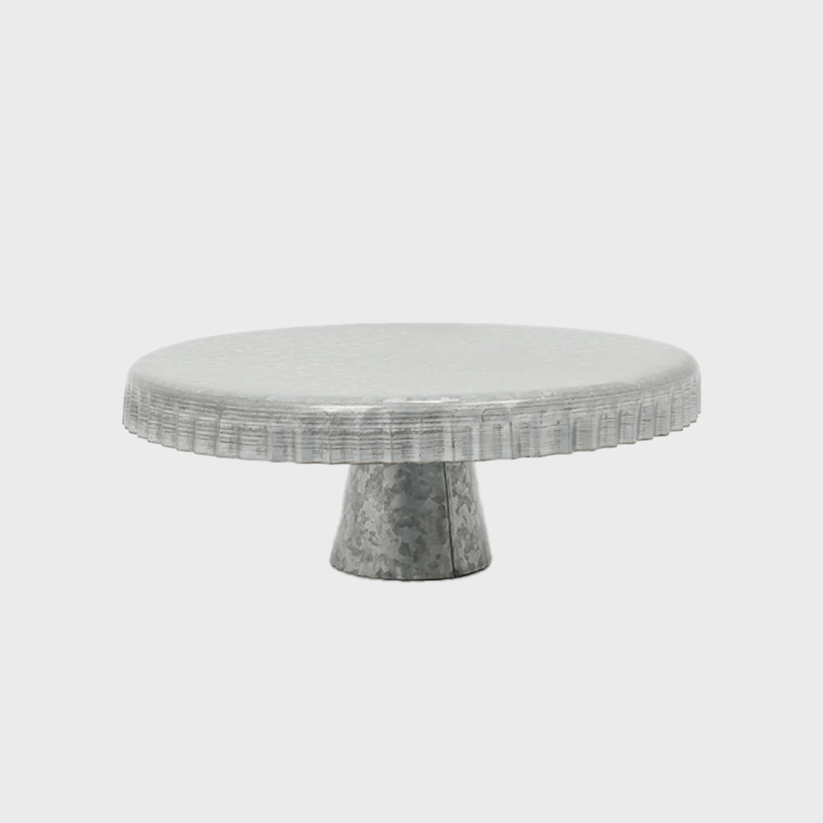 Galvanised metal cake stand with scalloped edge featuring a stable base and decorative scalloped edge.