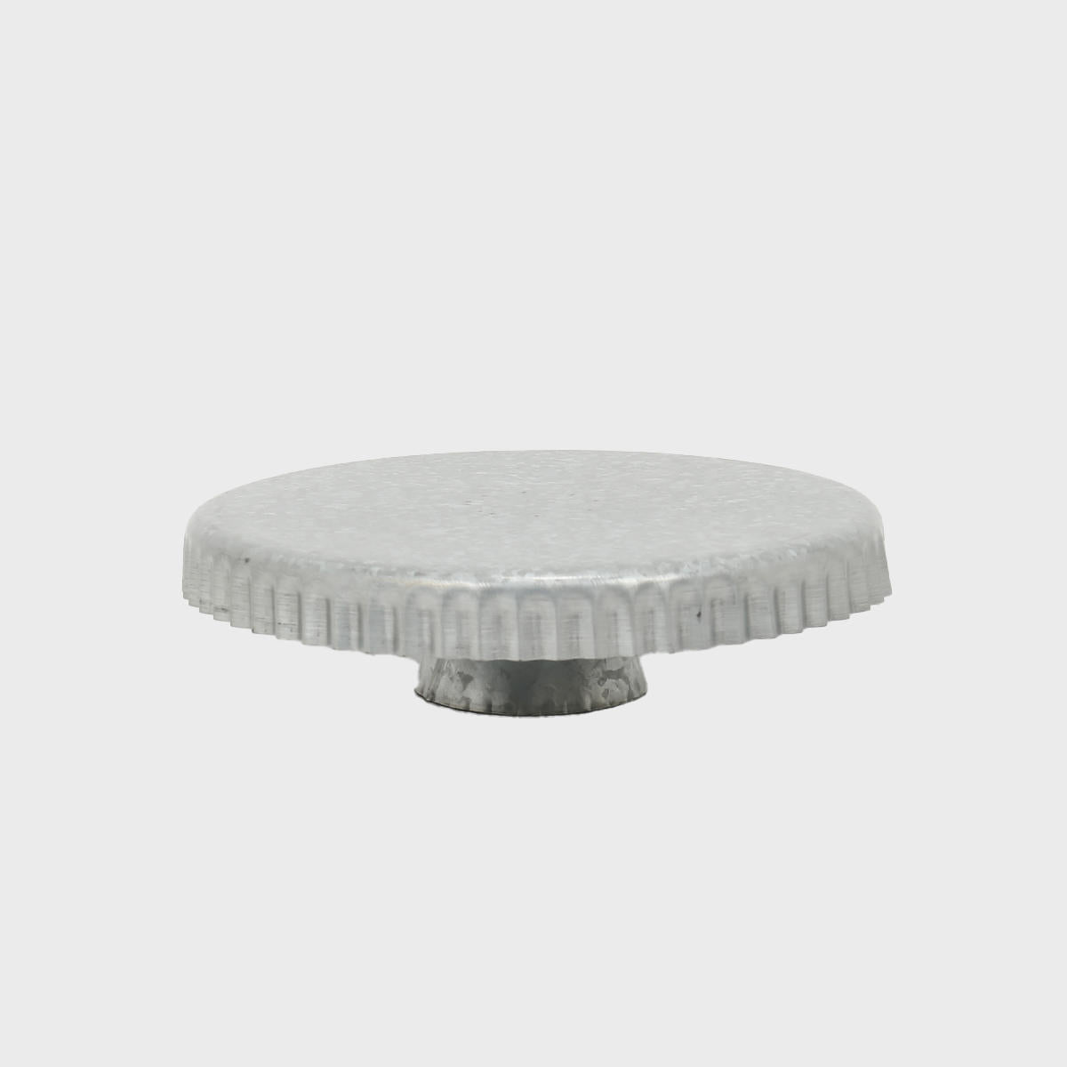 Galvanised metal cake stand with scalloped edge featuring a stable base and decorative scalloped edge.