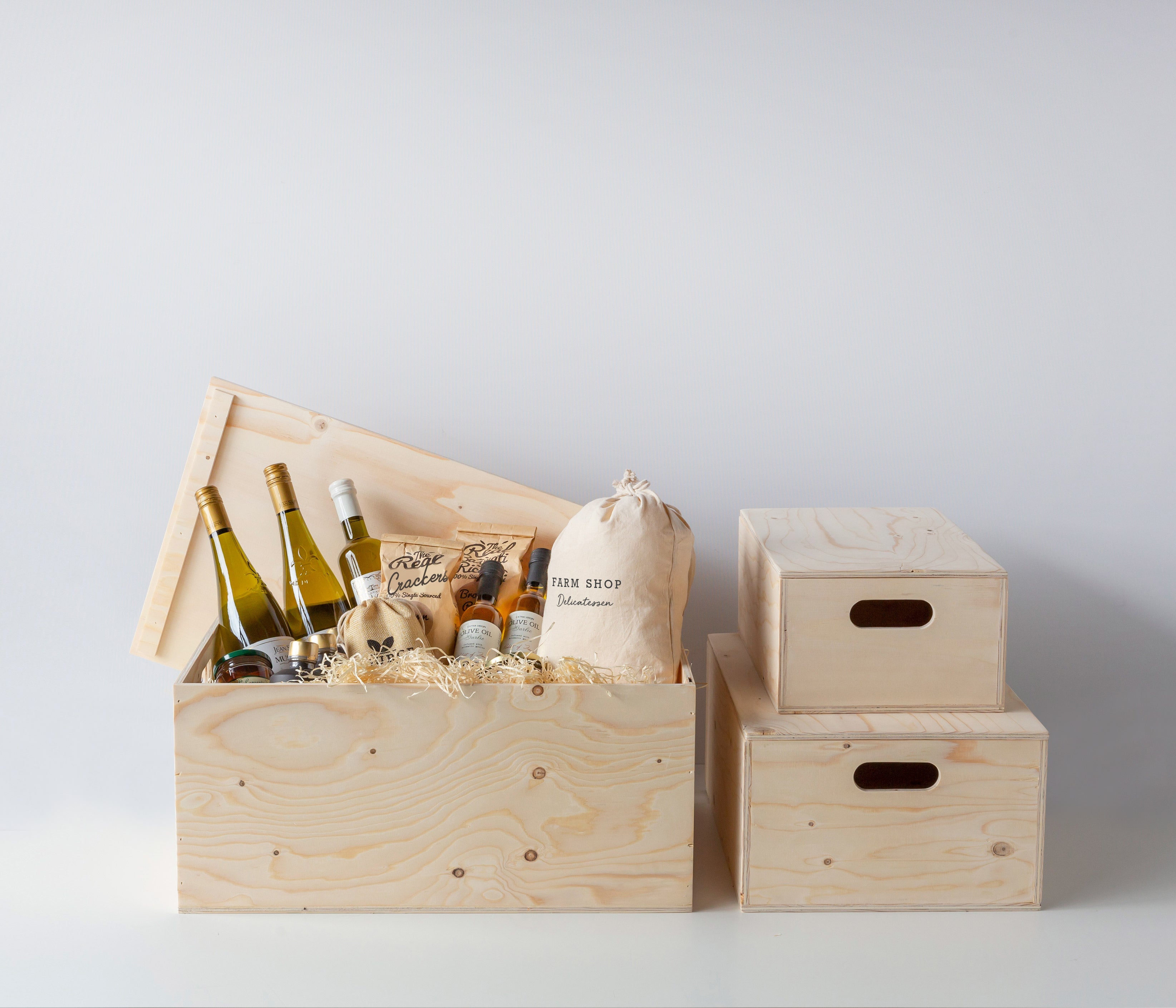 Wooden hamper box with drop on lid from high-density rigid paperboard.