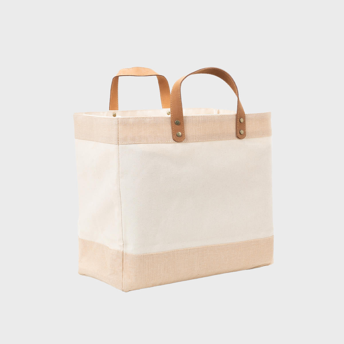 Large natural canvas market bag with leather handles.