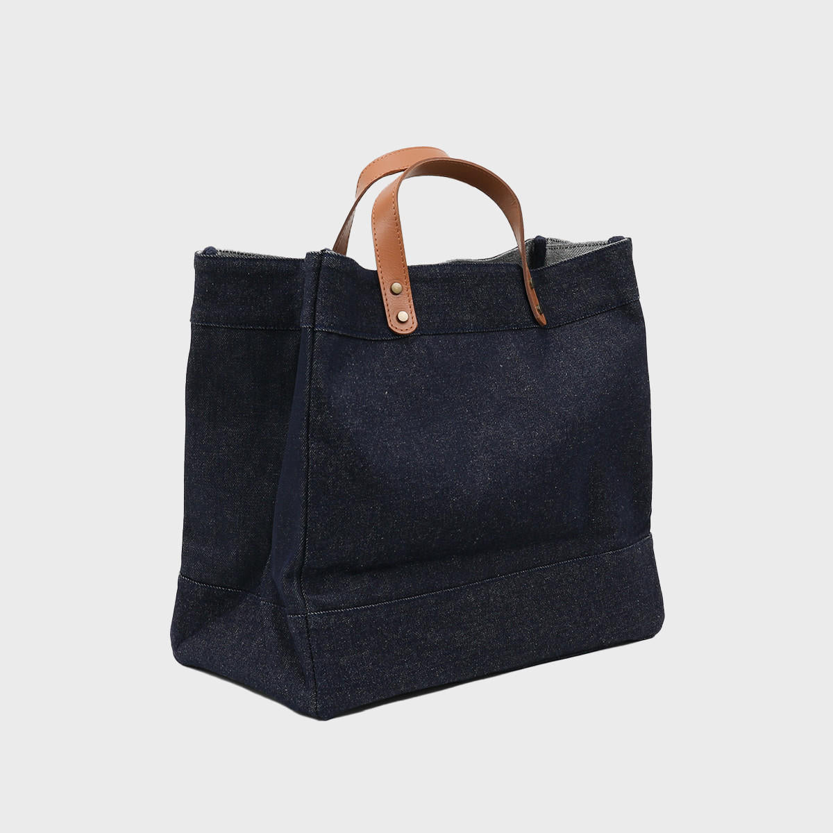 Large blue denim market bag with leather handles.