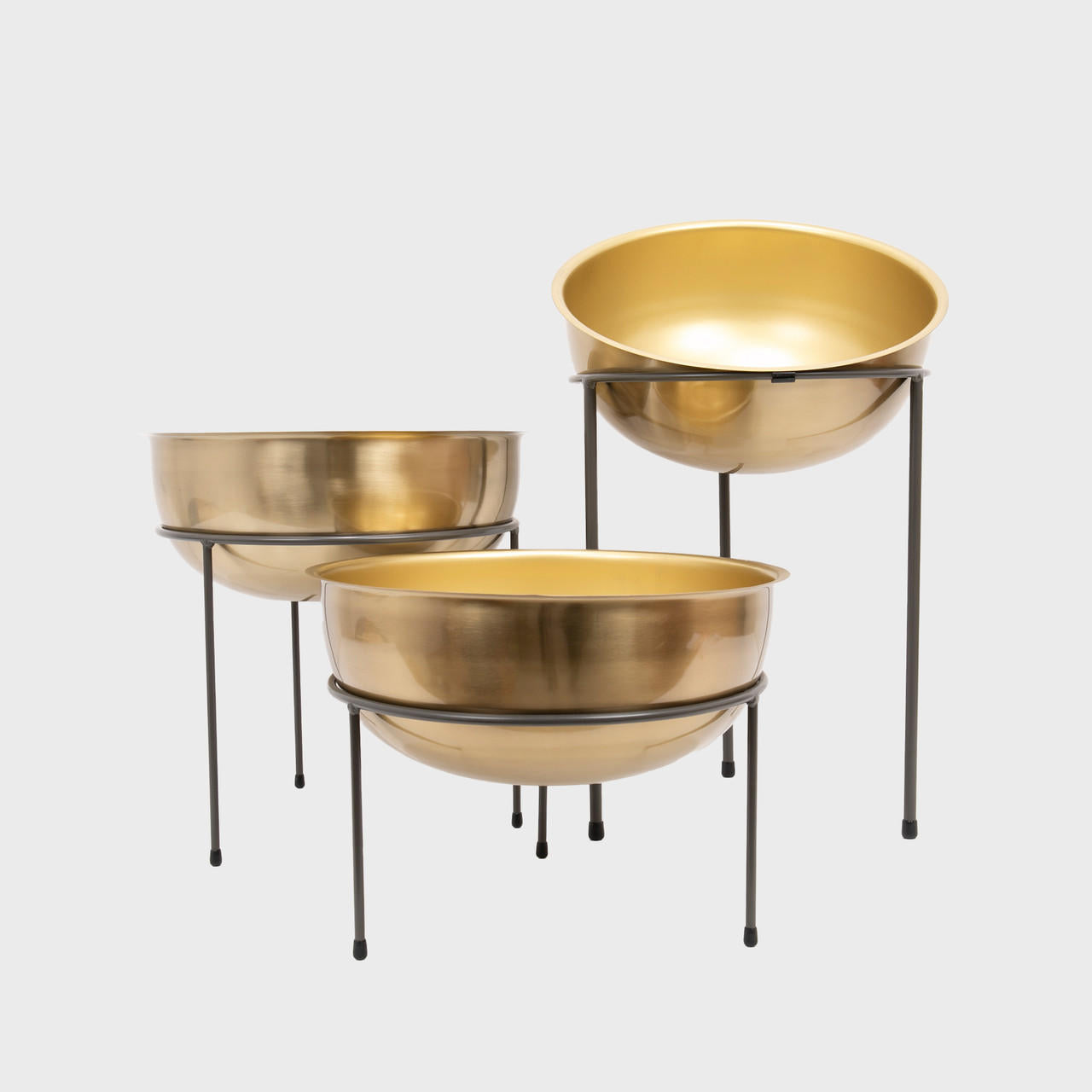 Matlock metal riser with matte brass bowl designed to add functional height and dimension.