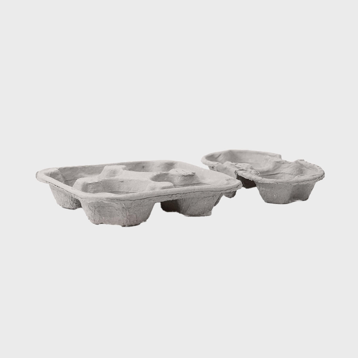 Pulp cup carrier tray with structured, low-profile walls and open-top design.