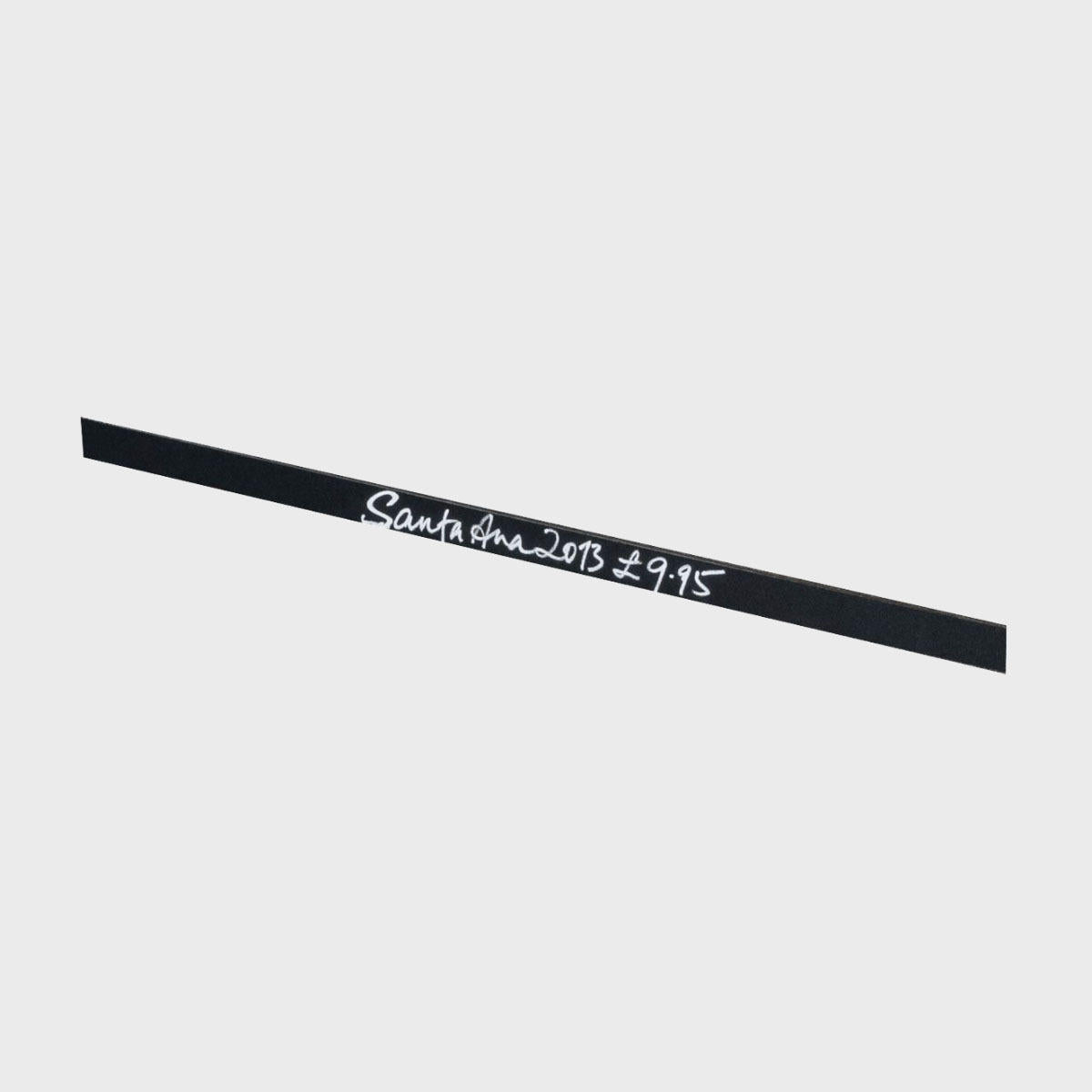 Self adhesive chalkboard signage strip with a clean surface for visible retail messaging.