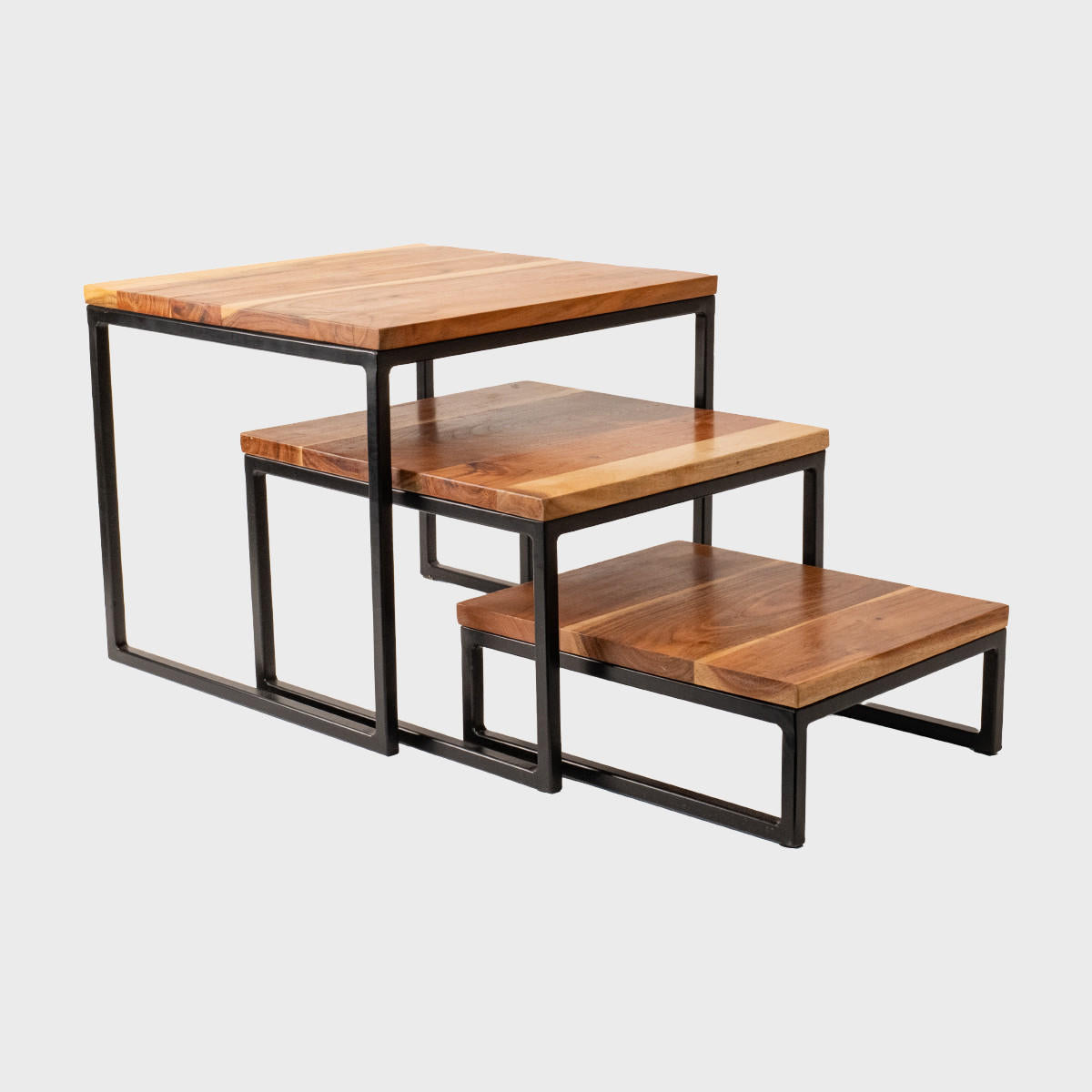 Natural acacia wood and steel riser set of 3 designed to add functional height and dimension.
