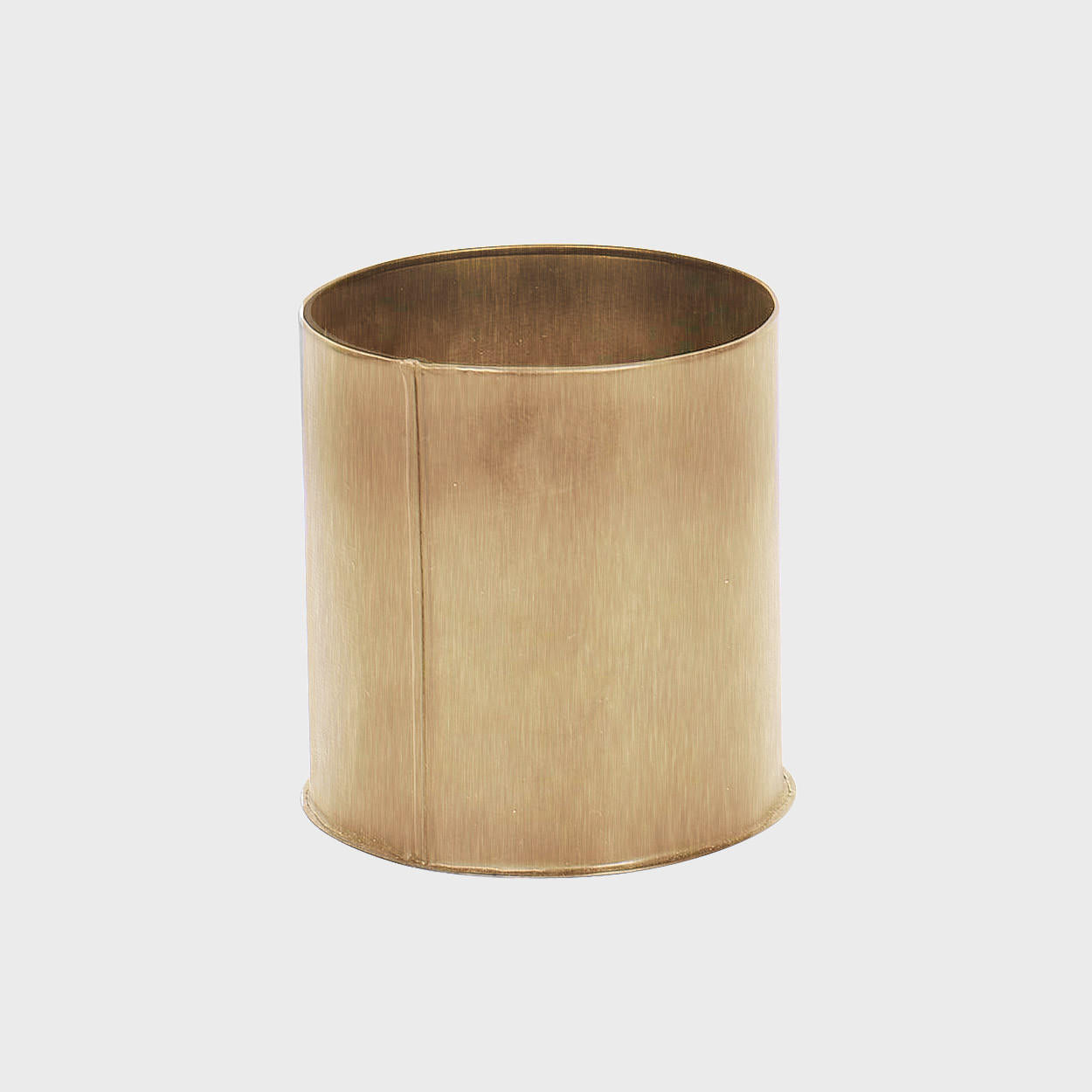 Small metal caddy with structured, low-profile walls and open-top design.