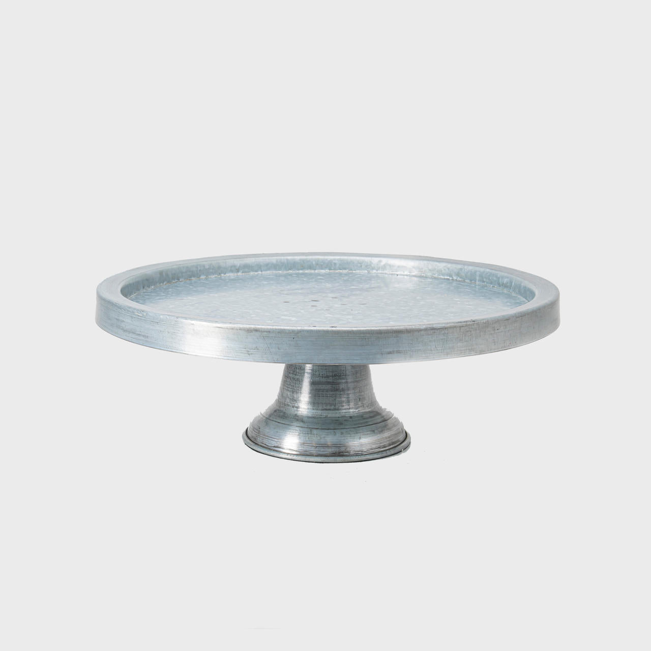 Galvanised metal rimmed cake stand featuring a stable base and decorative scalloped edge.