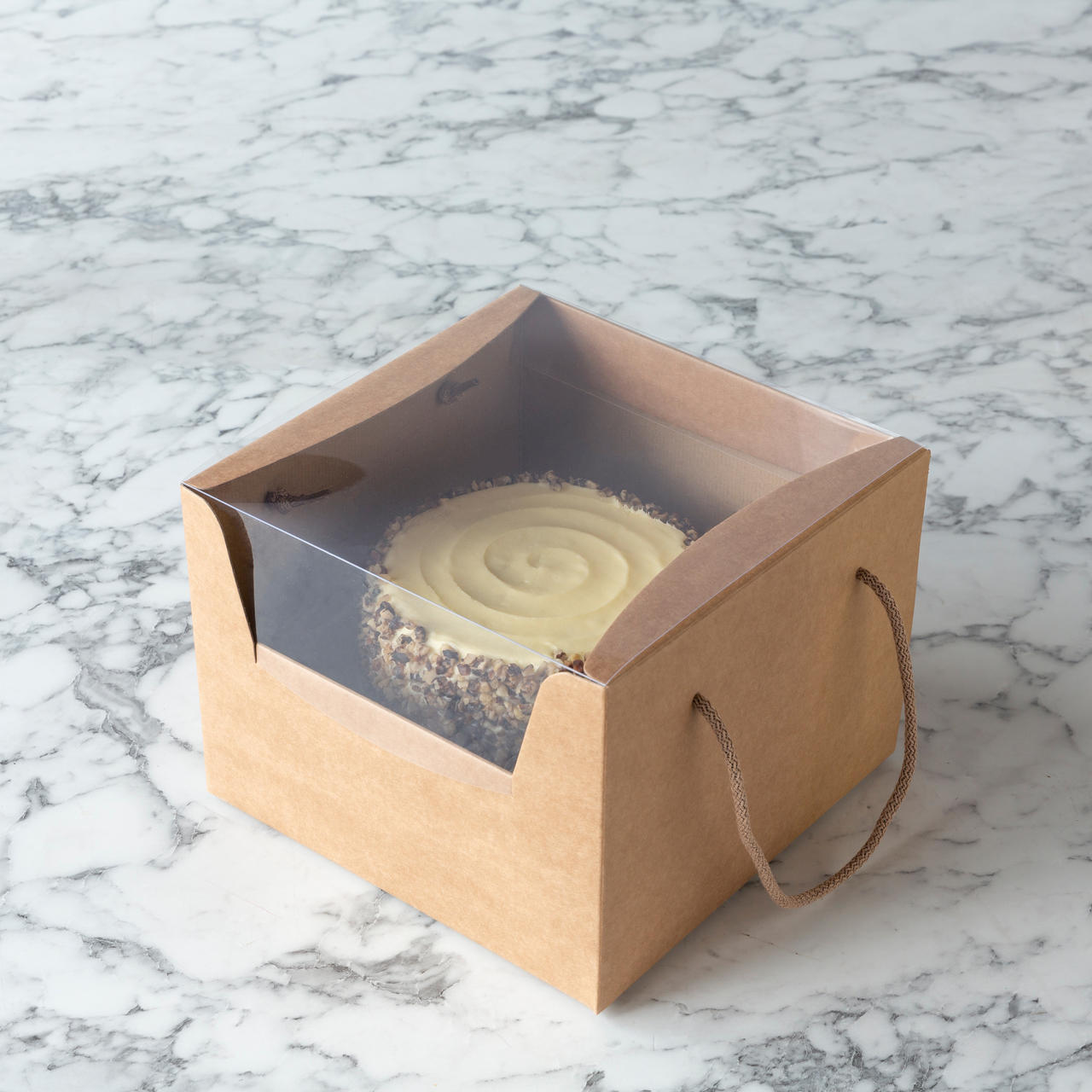 Kraft cake gift box with window and rope handles from high-density rigid paperboard.