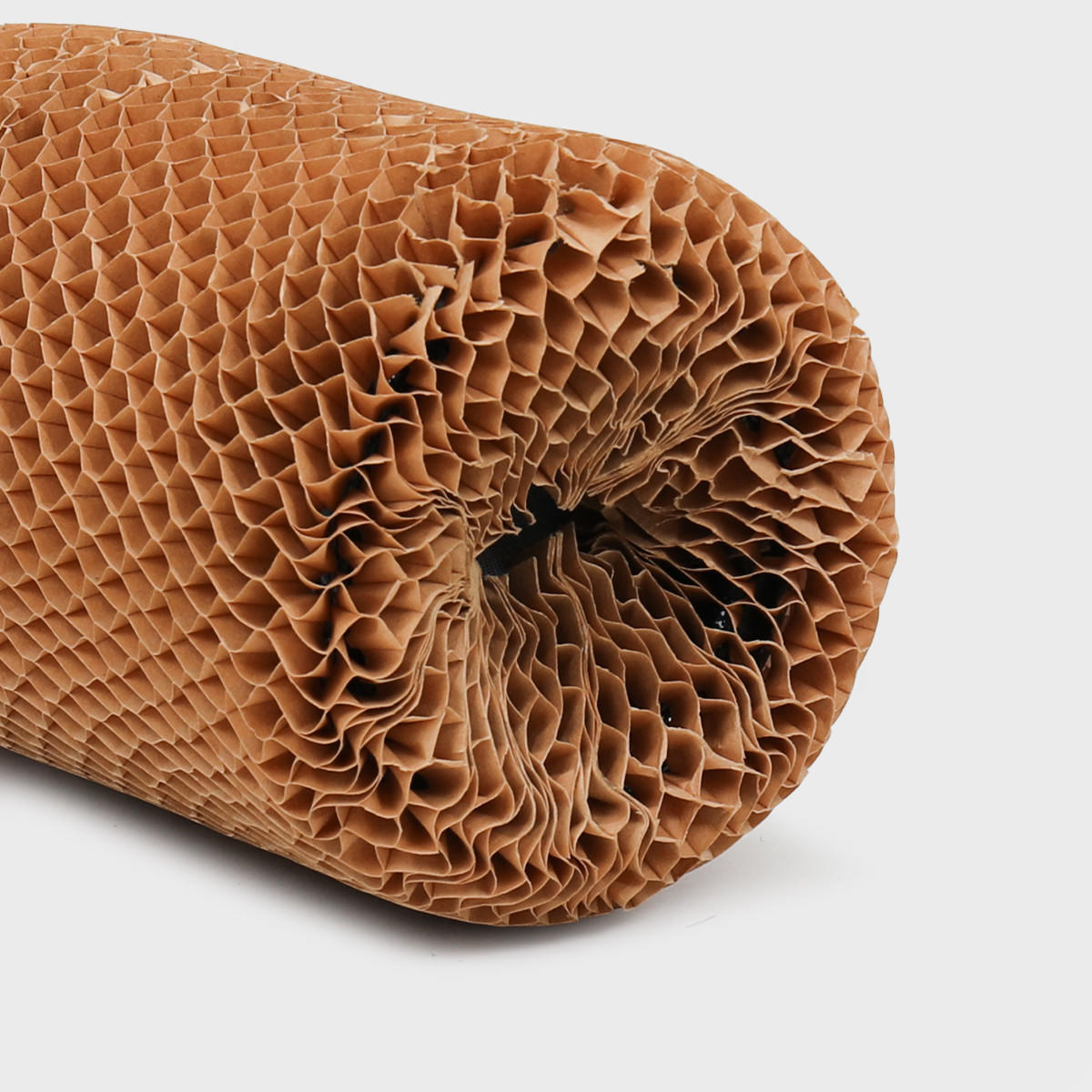 Honeycomb paper bottle protective sleeve made from robust corrugated cardboard for shock absorption.
