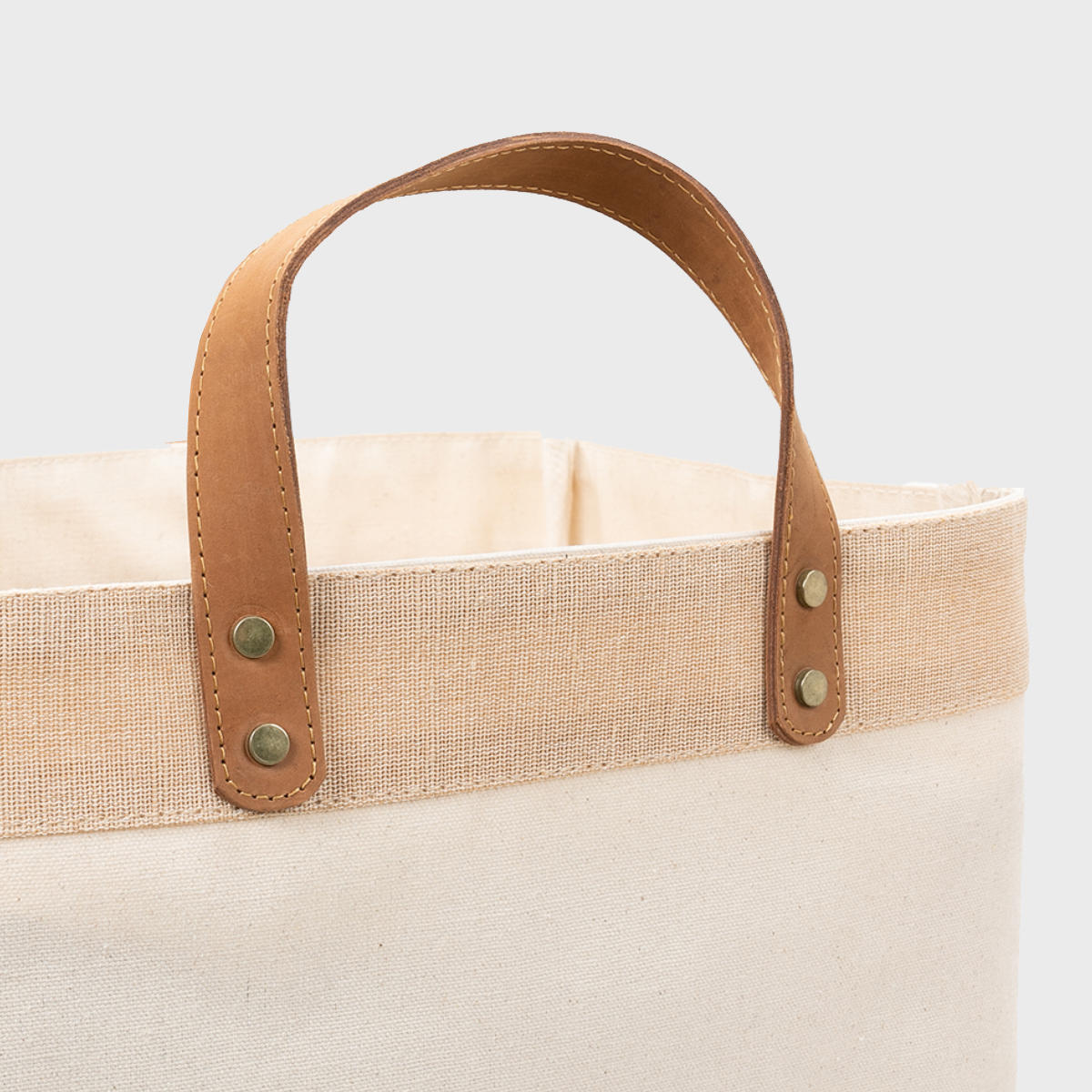 Large natural canvas market bag with leather handles.