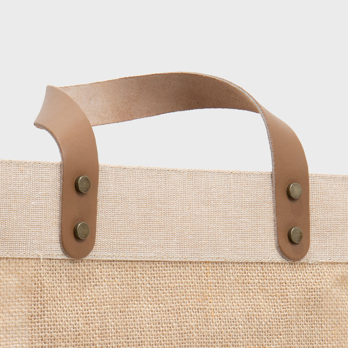 Large natural jute market bag with leather handles.