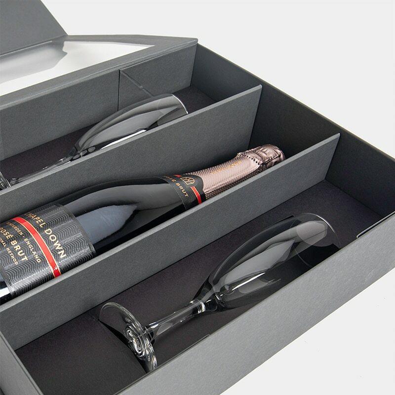 Magnetic bottle gift box with champagne flutes from high-density rigid paperboard.