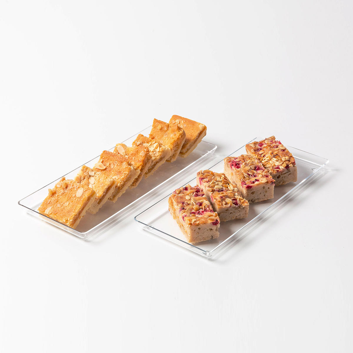 Acrylic loaf cake tray with structured, low-profile walls and open-top design.