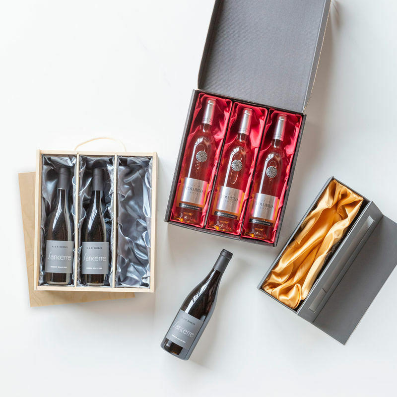 Silk lining for wooden bottle boxes with premium natural wood grain and secure hardware closures.