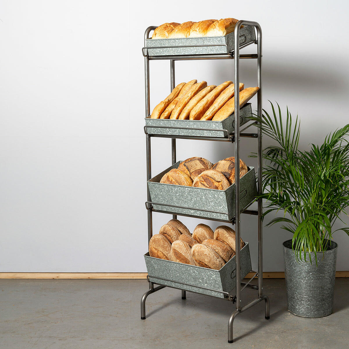 Camberwell retail stand 4 shelf with chatto chatto metal tray featuring a multi-tiered layout for product positioning.