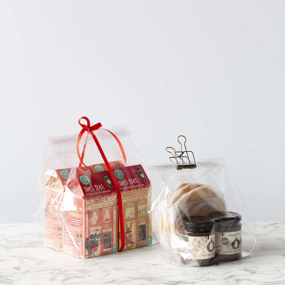 Cellophane gift bag featuring a patterned finish and heavy-duty handles.