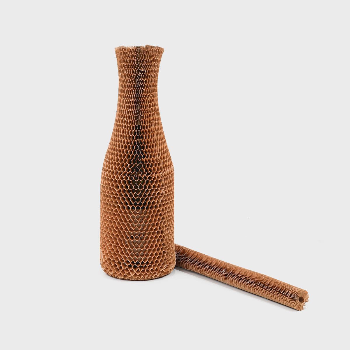 Honeycomb paper bottle protective sleeve made from robust corrugated cardboard for shock absorption.