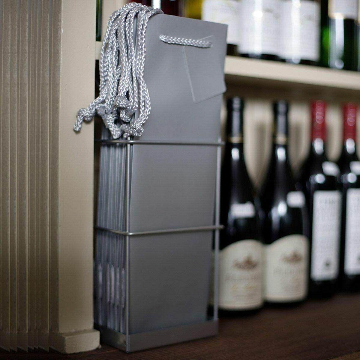 1 Bottle laminated gift bag featuring a patterned finish and heavy-duty handles.