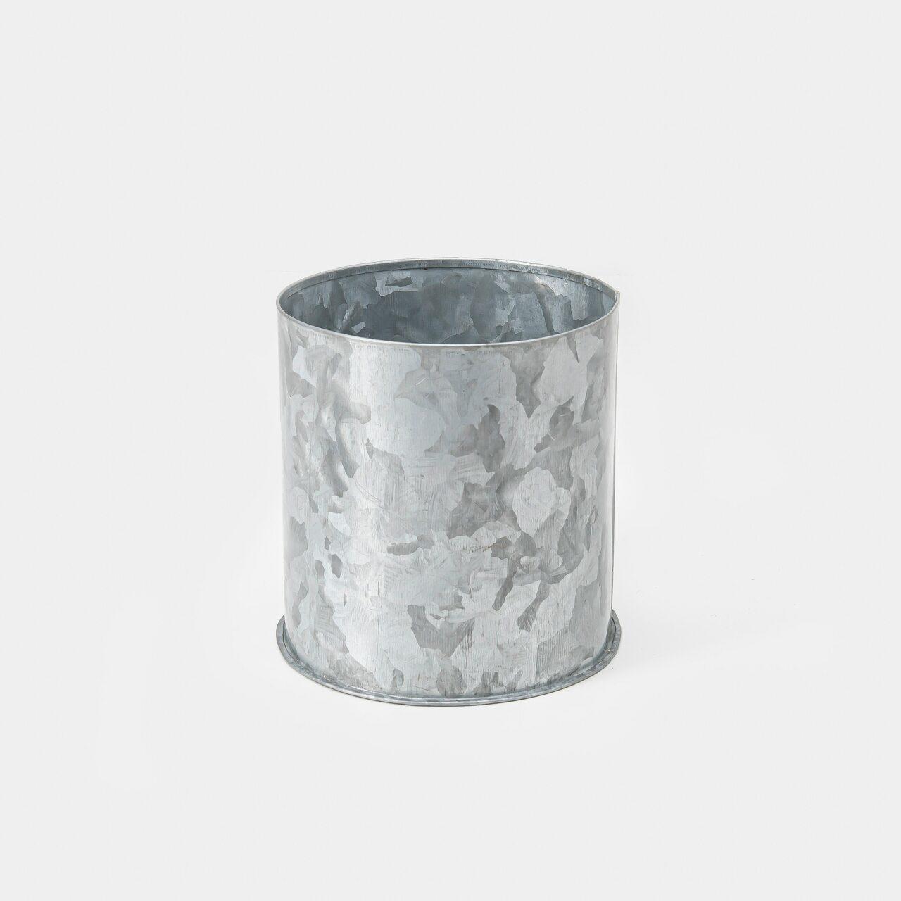 Small metal caddy with structured, low-profile walls and open-top design.