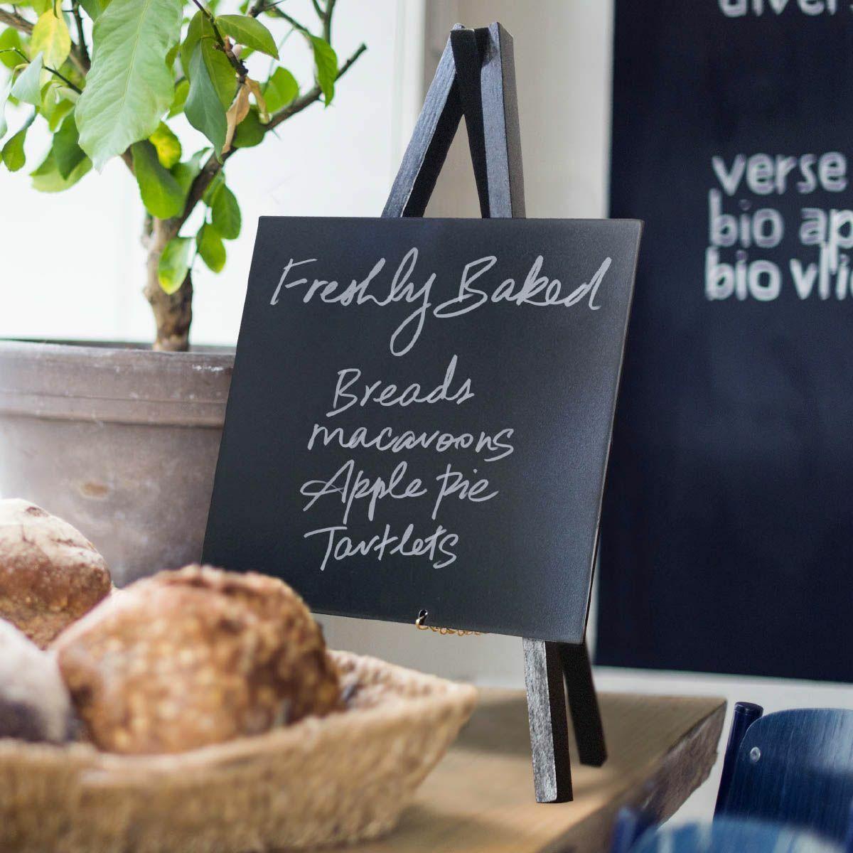 Mini-tripod chalkboard with a clean surface for visible retail messaging.