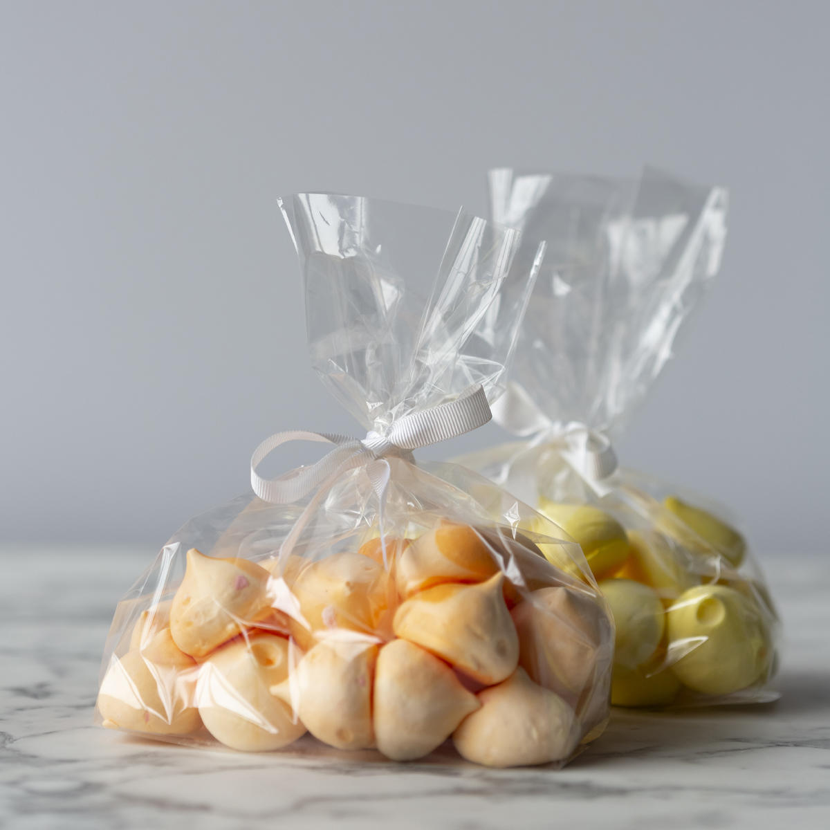 Cellophane gift bag featuring a patterned finish and heavy-duty handles.