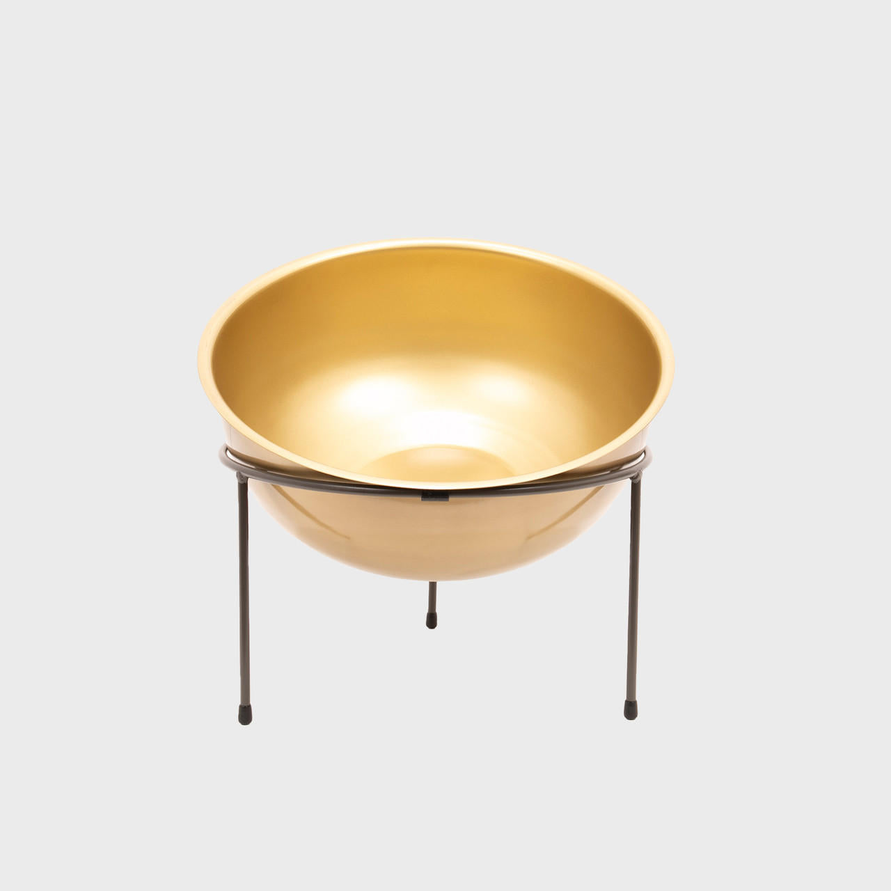 Matlock metal riser with matte brass bowl designed to add functional height and dimension.