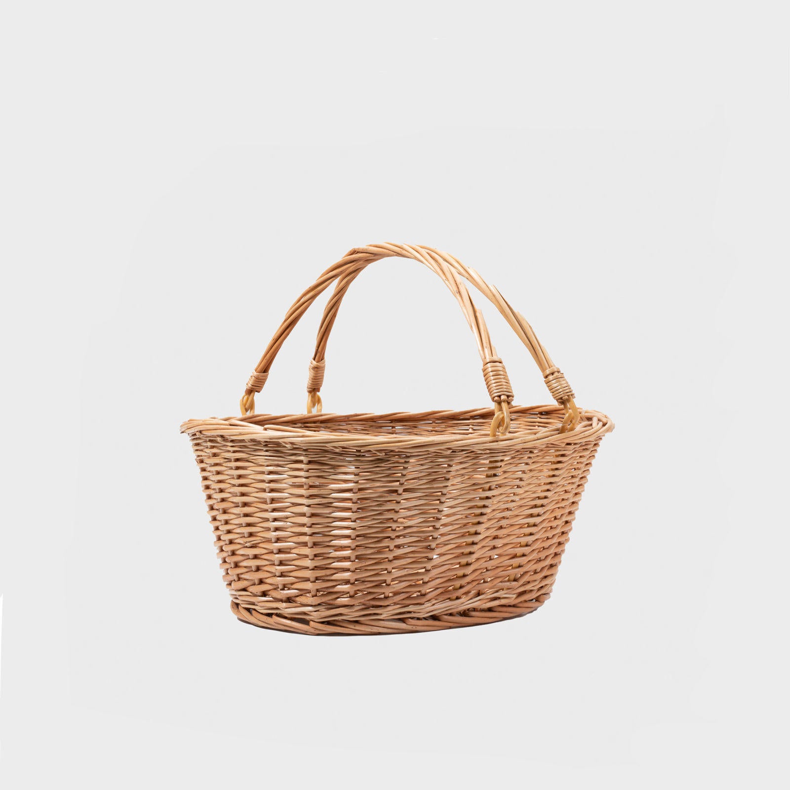 Medium oval natural wicker basket hand-woven from natural split-wicker.