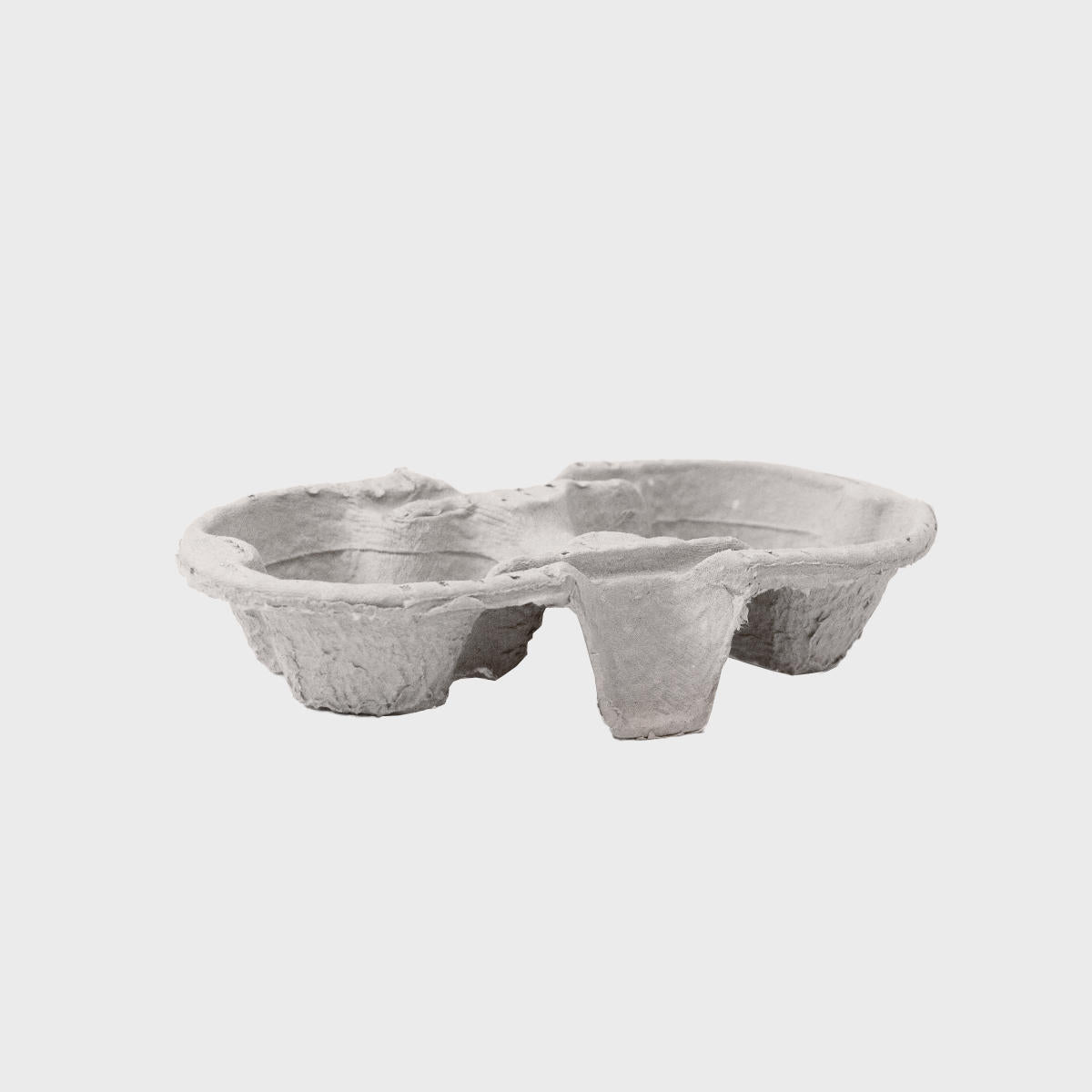 Pulp cup carrier tray with structured, low-profile walls and open-top design.